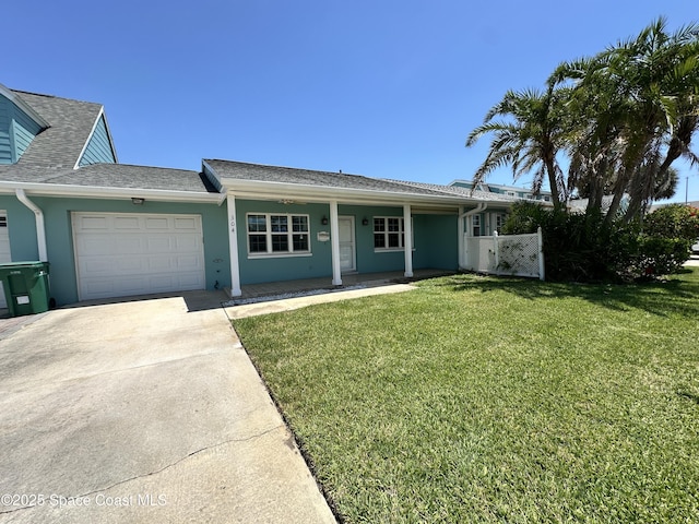 304 Emerald Pl E, Indian Harbour Beach, FL 32937 - ranch-style home featuring driveway, a garage, a front lawn, and stucco siding