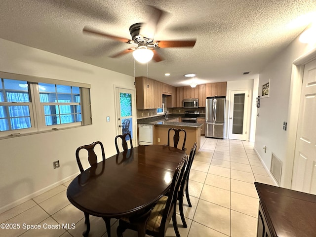 304 Emerald Pl E, Indian Harbour Beach, FL 32937 - dining area with light tile patterned floors, a textured ceiling, and ceiling fan