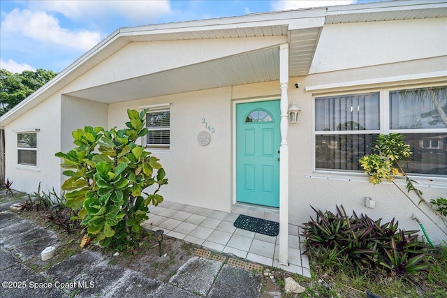 property entrance with stucco siding