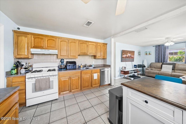 kitchen with white gas range oven, light tile patterned flooring, ceiling fan, dishwasher, and under cabinet range hood