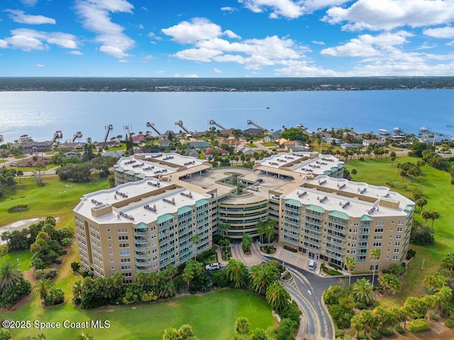 birds eye view of property with a water view and view of golf course