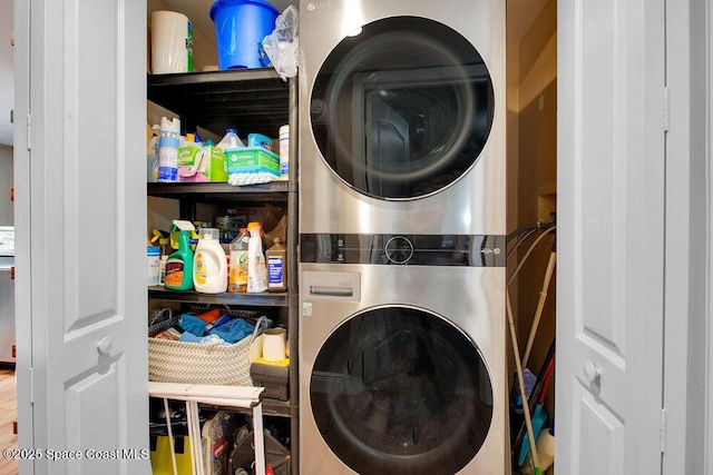 laundry room with stacked washer and clothes dryer and laundry area