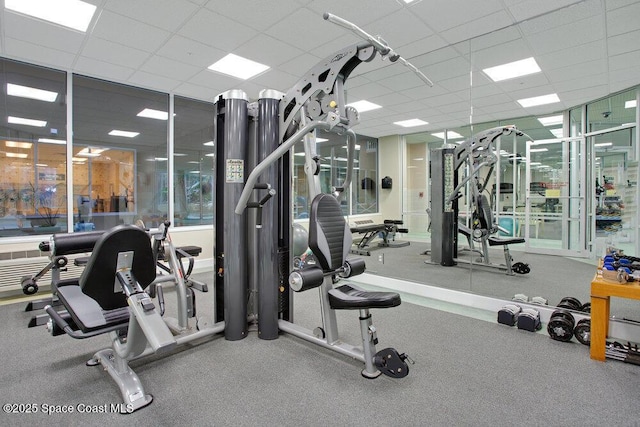 exercise room with a paneled ceiling