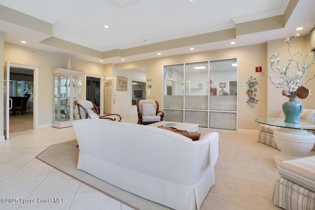 living area featuring recessed lighting, a tray ceiling, and ornamental molding