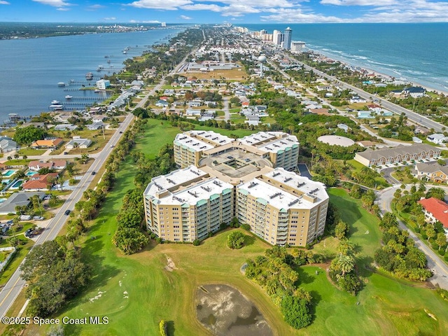 drone / aerial view with a water view and view of golf course