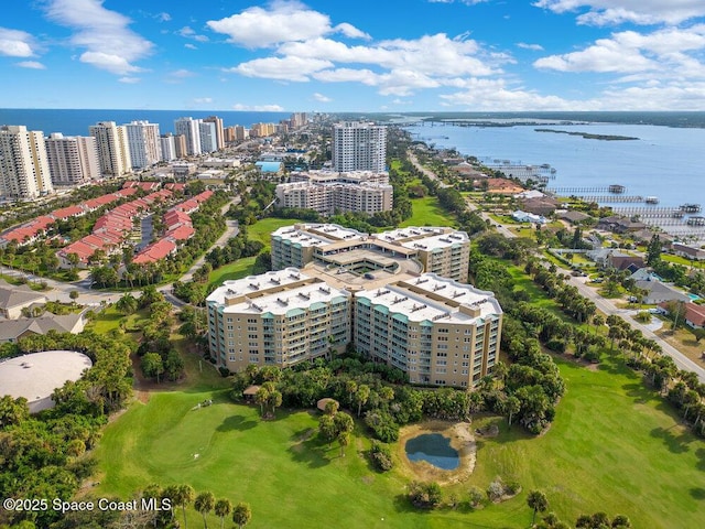 birds eye view of property with a water view and view of golf course