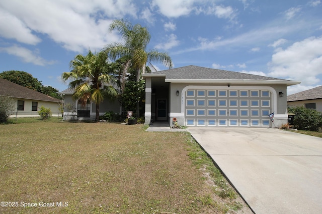 1867 Shannon St NW, Palm Bay, FL 32907 - view of front facade with stucco siding, concrete driveway, a front lawn, and a garage