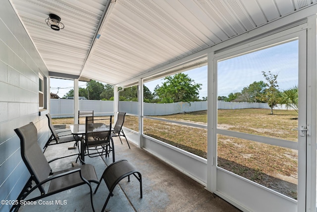 sunroom / solarium featuring outdoor dining area and plenty of natural light