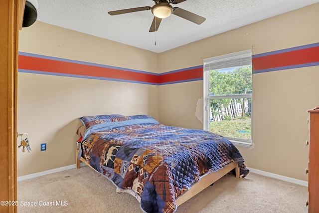 bedroom featuring a textured ceiling, carpet flooring, and multiple windows