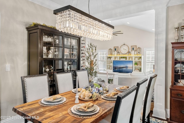 3592 S Park Ave, Titusville, FL 32780 - dining space with ceiling fan, a chandelier, crown molding, and lofted ceiling