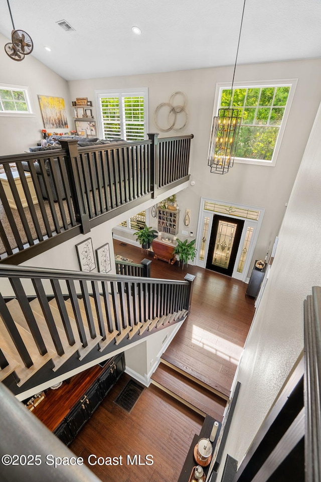 3592 S Park Ave, Titusville, FL 32780 - stairs with wood finished floors, a chandelier, healthy amount of natural light, and recessed lighting