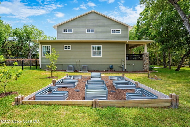 3592 S Park Ave, Titusville, FL 32780 - rear view of house featuring a vegetable garden and central AC unit