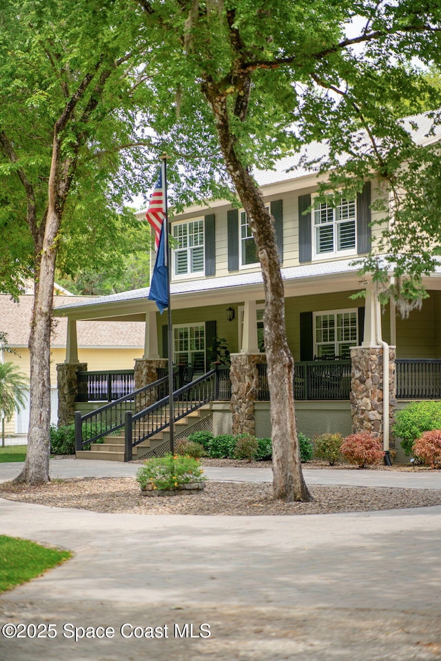 3592 S Park Ave, Titusville, FL 32780 - view of front of home featuring covered porch and stone siding
