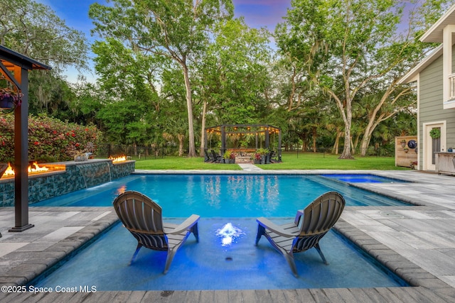 3592 S Park Ave, Titusville, FL 32780 - view of pool featuring an outdoor fire pit, a gazebo, view of wooded area, and a patio area