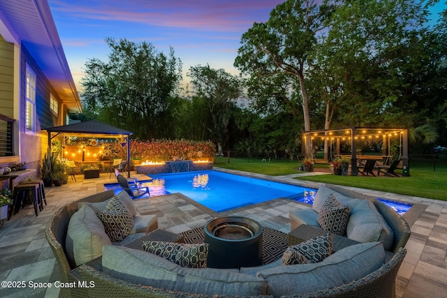 3592 S Park Ave, Titusville, FL 32780 - swimming pool with a gazebo, an outdoor living space with a fire pit, a patio, and a lawn