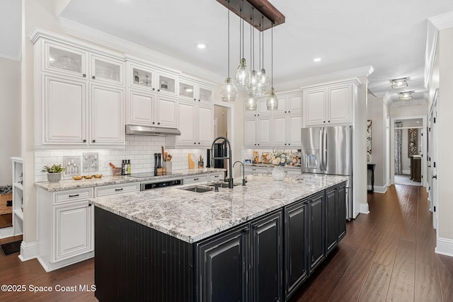 3592 S Park Ave, Titusville, FL 32780 - kitchen featuring white cabinets, dark cabinets, tasteful backsplash, a kitchen island with sink, and hanging light fixtures