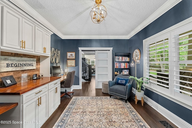 3592 S Park Ave, Titusville, FL 32780 - office space with built in desk, dark wood-style floors, a textured ceiling, baseboards, and ornamental molding