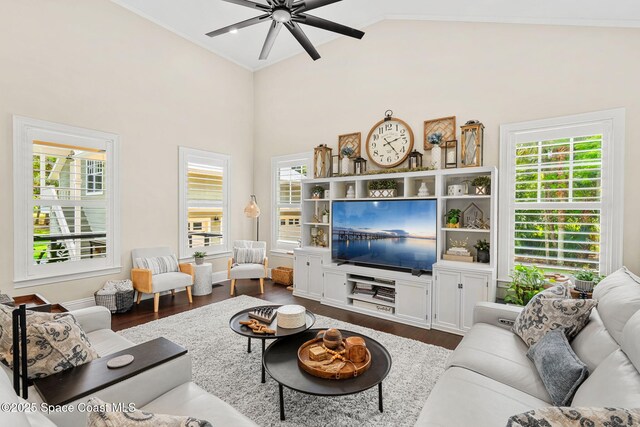 3592 S Park Ave, Titusville, FL 32780 - living room featuring dark wood-style flooring, plenty of natural light, ceiling fan, crown molding, and high vaulted ceiling
