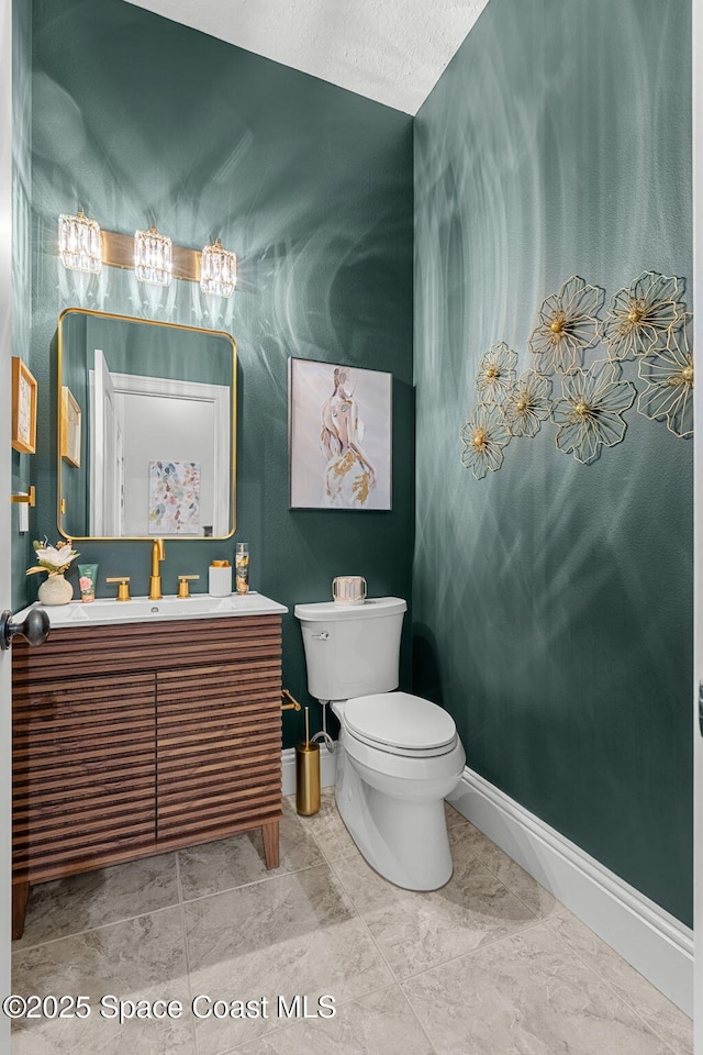 3592 S Park Ave, Titusville, FL 32780 - bathroom with baseboards, toilet, and vanity