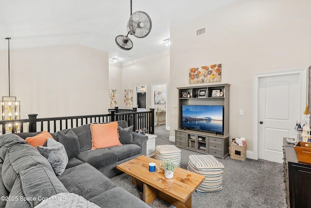 3592 S Park Ave, Titusville, FL 32780 - carpeted living room featuring a chandelier, high vaulted ceiling, and baseboards