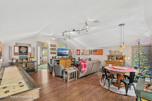 3592 S Park Ave, Titusville, FL 32780 - living room featuring lofted ceiling, wood finished floors, and a textured ceiling