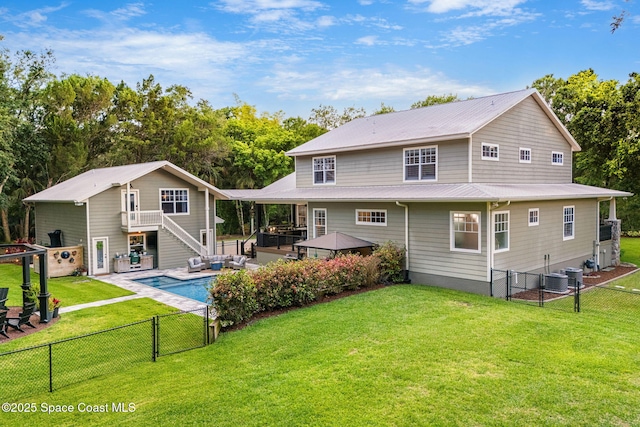 3592 S Park Ave, Titusville, FL 32780 - back of house featuring a gate, stairway, metal roof, and a patio area
