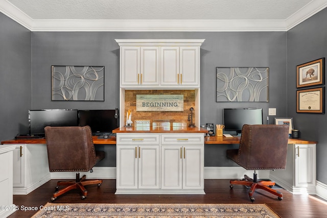 3592 S Park Ave, Titusville, FL 32780 - home office featuring built in desk, dark wood-type flooring, ornamental molding, and baseboards