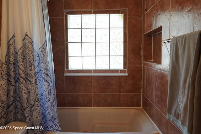 bathroom featuring a combined bath / shower with jetted tub and toilet
