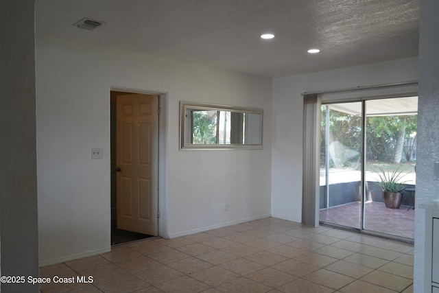 unfurnished room with recessed lighting, light tile patterned flooring, visible vents, and baseboards