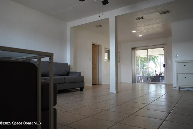 living area featuring visible vents, ceiling fan, and tile patterned flooring