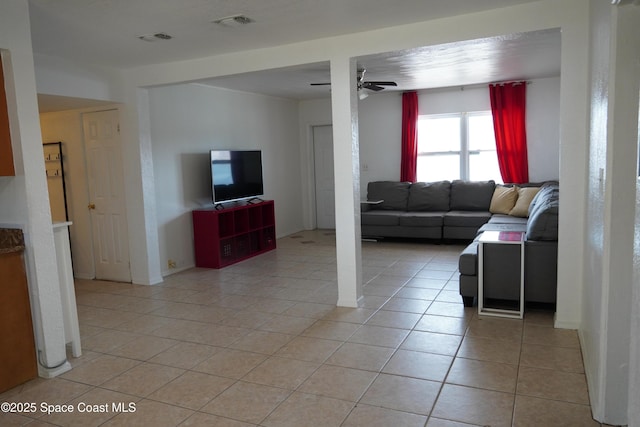 living area with visible vents, light tile patterned floors, and a ceiling fan