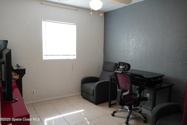 office featuring a ceiling fan, tile patterned flooring, and baseboards