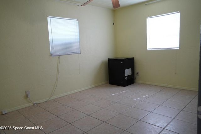 spare room featuring light tile patterned floors and ceiling fan