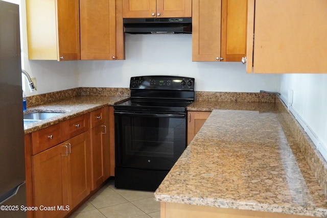 kitchen featuring a sink, under cabinet range hood, light tile patterned floors, black range with electric stovetop, and light stone counters