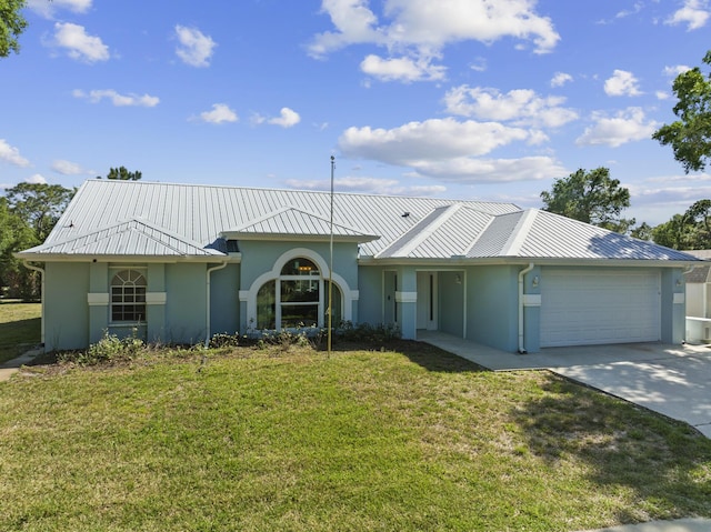 view of front of property with metal roof, a garage, and stucco siding