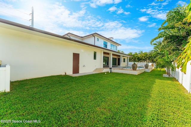 2355 N Riverside Dr, Indialantic, FL 32903 - rear view of property featuring a lawn, a fenced in pool, stucco siding, and a fenced backyard