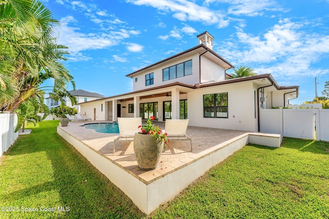 2355 N Riverside Dr, Indialantic, FL 32903 - rear view of house with ceiling fan, a patio area, a fenced backyard, a yard, and stucco siding