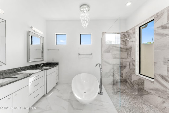 2355 N Riverside Dr, Indialantic, FL 32903 - full bath with double vanity, a freestanding tub, baseboards, marble finish floor, and tiled shower