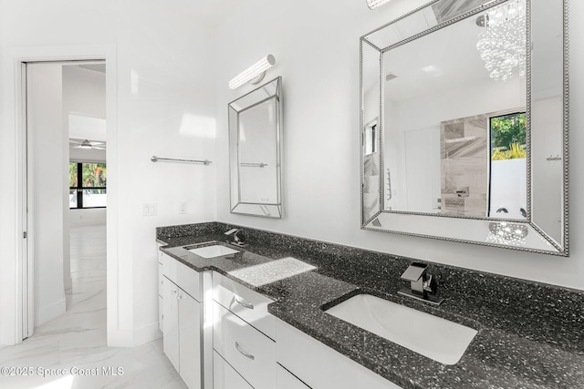 2355 N Riverside Dr, Indialantic, FL 32903 - bathroom with baseboards, a sink, marble finish floor, and double vanity