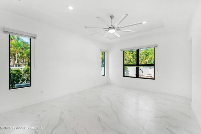 2355 N Riverside Dr, Indialantic, FL 32903 - empty room featuring baseboards, ceiling fan, marble finish floor, and a wealth of natural light