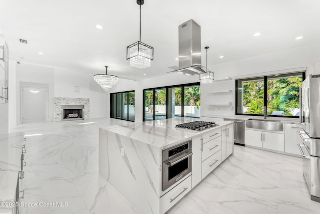 2355 N Riverside Dr, Indialantic, FL 32903 - kitchen with island range hood, appliances with stainless steel finishes, modern cabinets, a sink, and marble finish floor