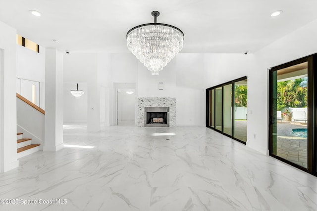 2355 N Riverside Dr, Indialantic, FL 32903 - unfurnished living room featuring a notable chandelier, marble finish floor, stairs, recessed lighting, and baseboards