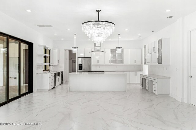 2355 N Riverside Dr, Indialantic, FL 32903 - kitchen with visible vents, marble finish floor, appliances with stainless steel finishes, and a kitchen island