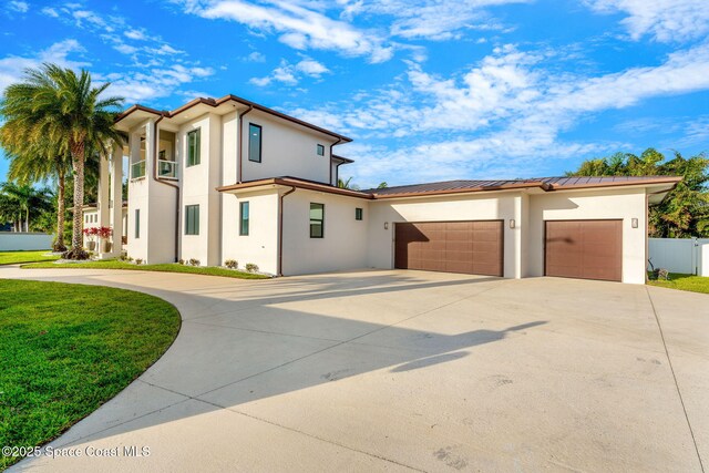 2355 N Riverside Dr, Indialantic, FL 32903 - mediterranean / spanish-style home featuring a garage, fence, stucco siding, and concrete driveway