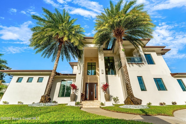 2355 N Riverside Dr, Indialantic, FL 32903 - view of front of house with stucco siding and a front yard