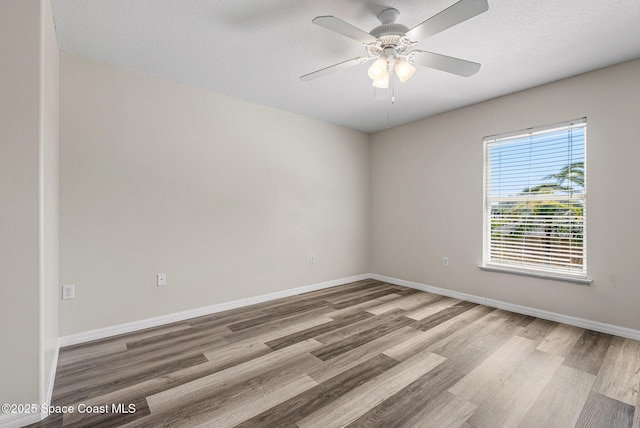 1701 Brookshire Cir, Melbourne, FL 32904 - spare room with baseboards, ceiling fan, a textured ceiling, and wood finished floors