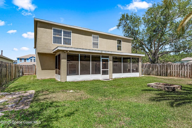 1701 Brookshire Cir, Melbourne, FL 32904 - back of property featuring a yard, a fire pit, a fenced backyard, and a sunroom