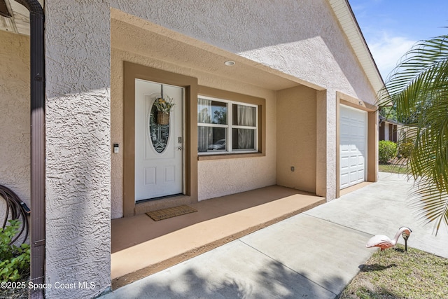 1044 Bernice Rd, Rockledge, FL 32955 - view of exterior entry with an attached garage and stucco siding