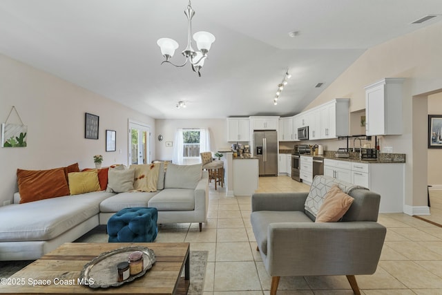 1044 Bernice Rd, Rockledge, FL 32955 - living room with an inviting chandelier, vaulted ceiling, light tile patterned flooring, and visible vents