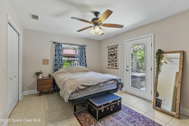 1044 Bernice Rd, Rockledge, FL 32955 - bedroom with baseboards, light tile patterned floors, multiple windows, and access to exterior